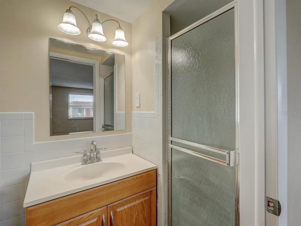 10320 Honeysuckle Lane Port Richey, FL 34668 - Photo 23 of 53 a bathroom with a sink and a mirror
