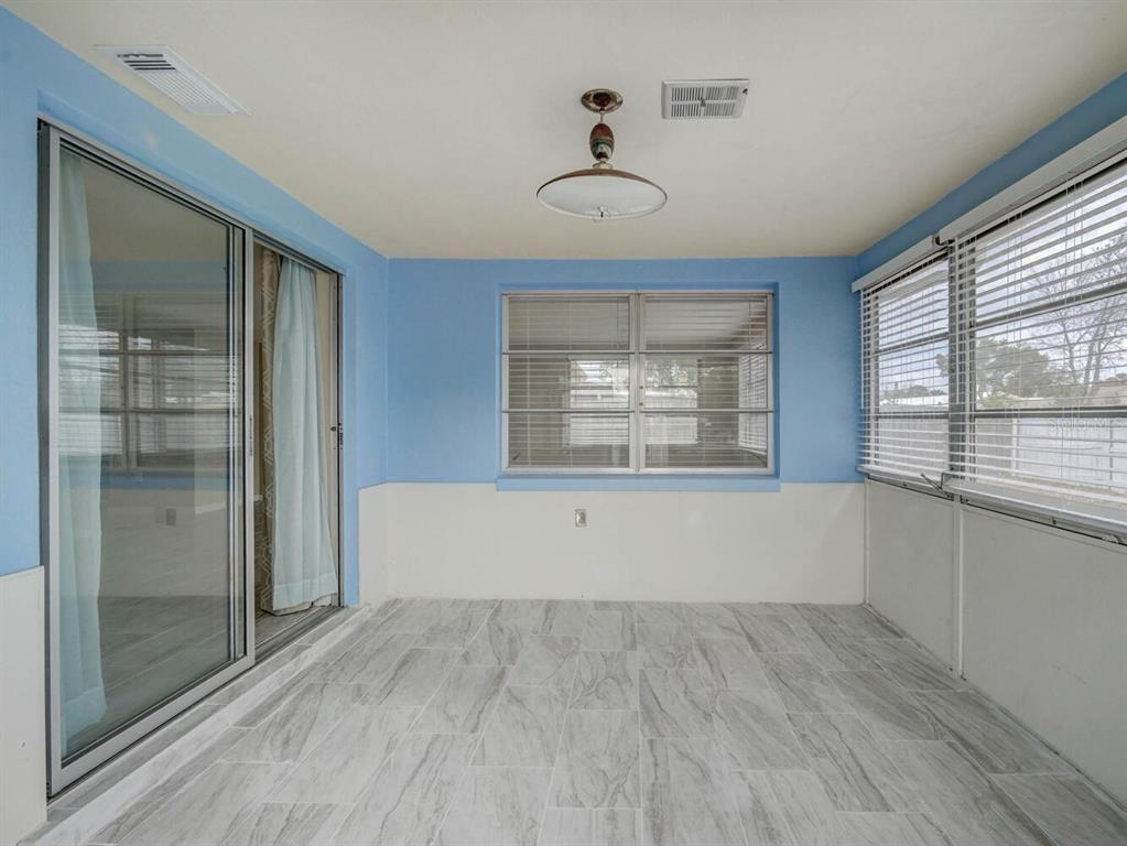 10320 Honeysuckle Lane Port Richey, FL 34668 - Photo 29 of 53 a view of empty room with wooden floor and fan