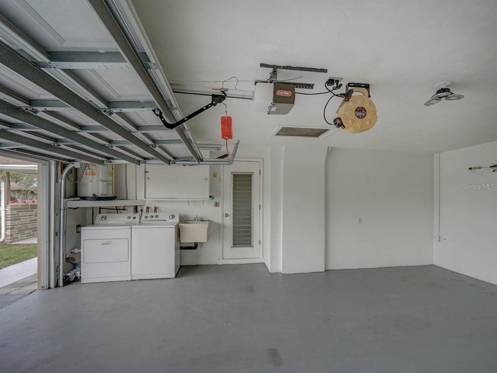 10320 Honeysuckle Lane Port Richey, FL 34668 - Photo 33 of 53 a storage room with washer and dryer