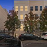 a front view of a residential apartment building with a yard