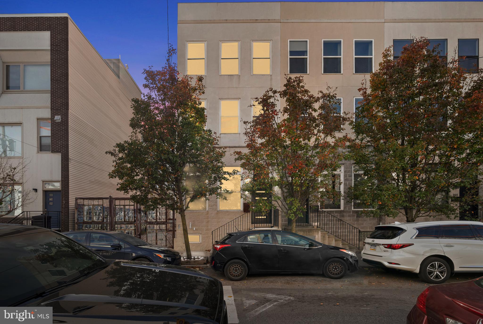 a front view of a residential apartment building with a yard