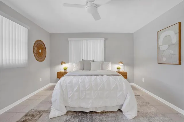 a bed room with a bed and a painting on the wall