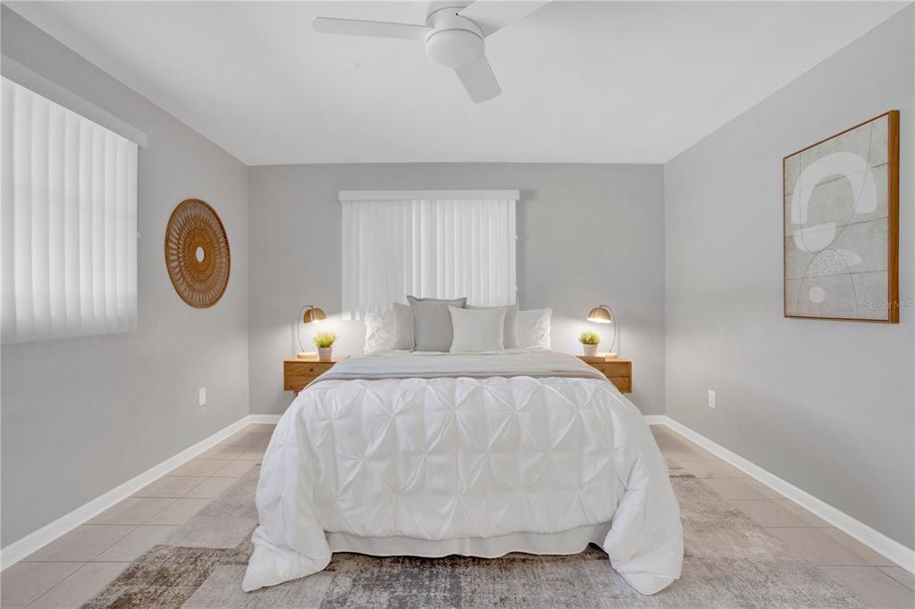 2481 12th Avenue Southwest Largo, FL 33770 - Photo 12 of 21 a bed room with a bed and a painting on the wall