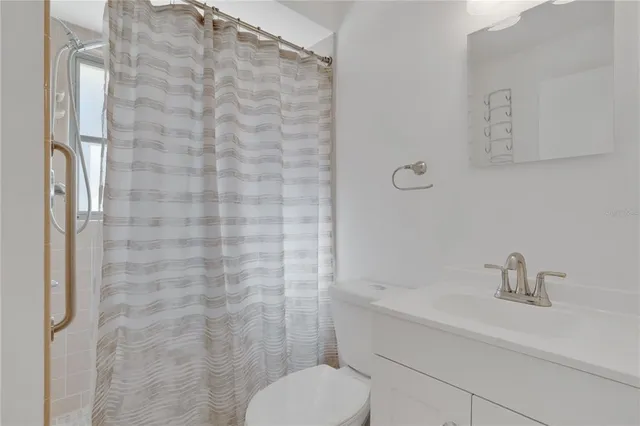 a bathroom with a toilet sink and shower