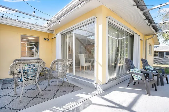 a dining room with furniture wooden floor and glass windows
