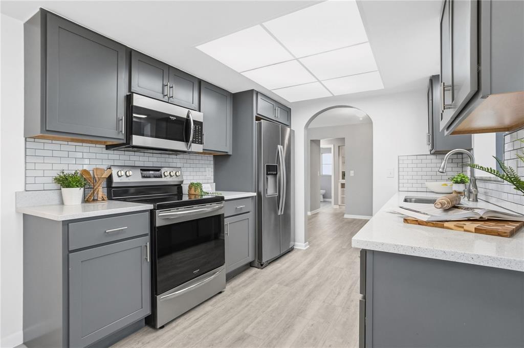 2481 12th Avenue Southwest Largo, FL 33770 - Photo 4 of 21 a kitchen with stainless steel appliances a sink cabinets and wooden floor