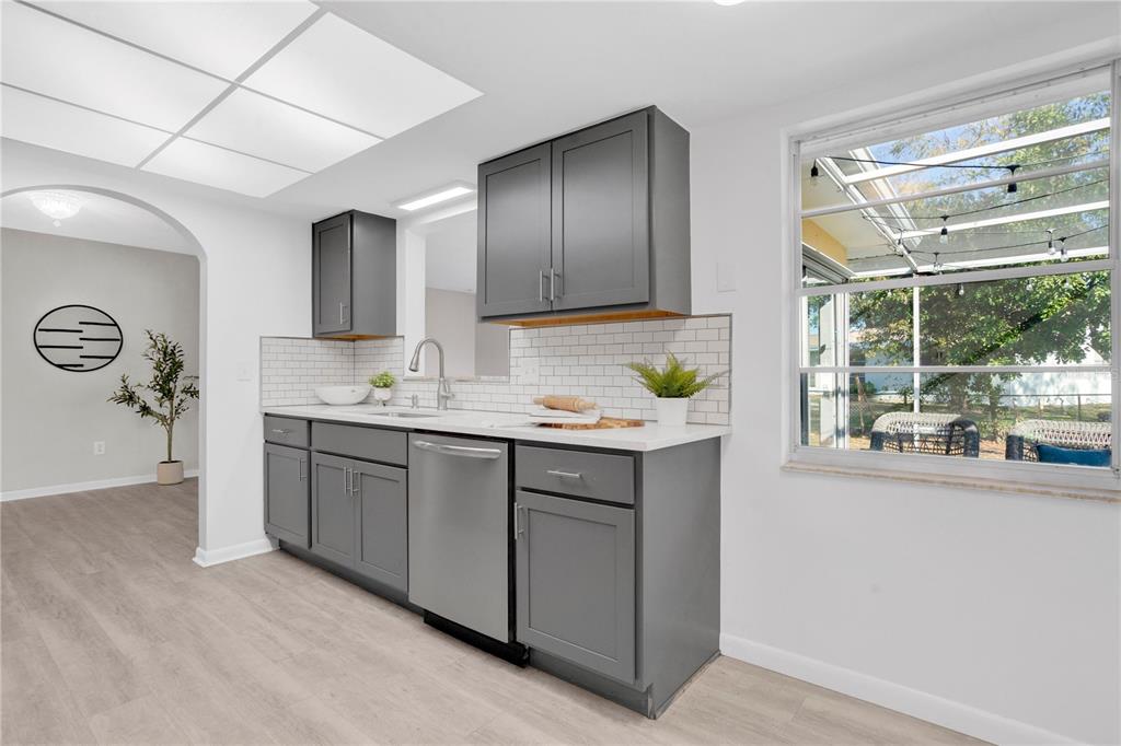 2481 12th Avenue Southwest Largo, FL 33770 - Photo 7 of 21 a kitchen with kitchen island granite countertop a sink window and cabinets