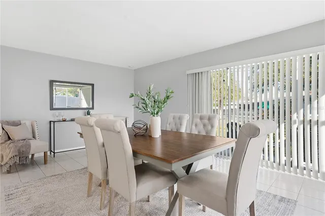 a view of a dining room with furniture and a potted plant