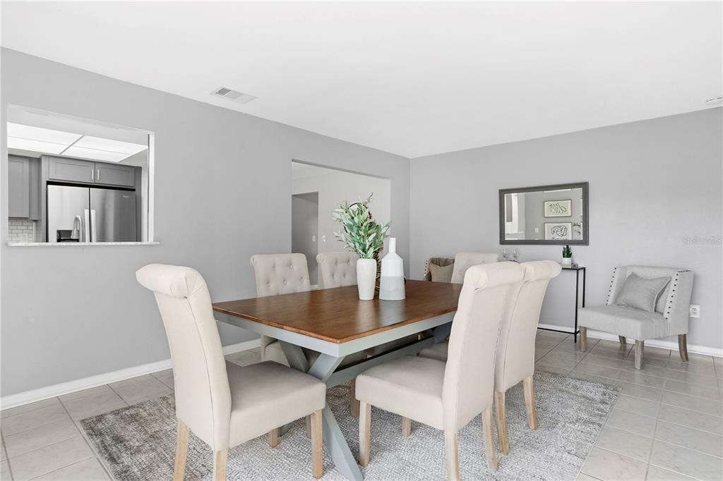 2481 12th Avenue Southwest Largo, FL 33770 - Photo 10 of 21 a view of a dining room with furniture and wooden floor