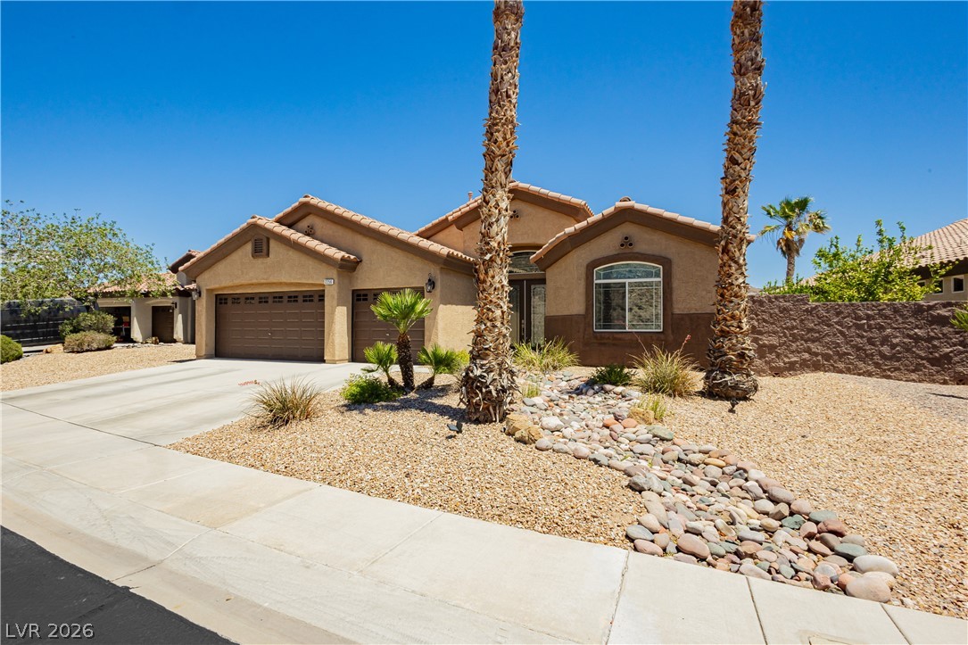 2256 Dogwood Ranch Avenue Henderson, NV 89052 - Photo 3 of 51 A well-maintained desert landscape frames this welcoming single-story home with a double garage.