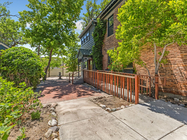 12825 South Fort Street Draper, UT 84020 - Photo 40 of 52 Brick and clapboard exterior featuring a covered entry, established landscaping, a paved walkway, and a ramp access point