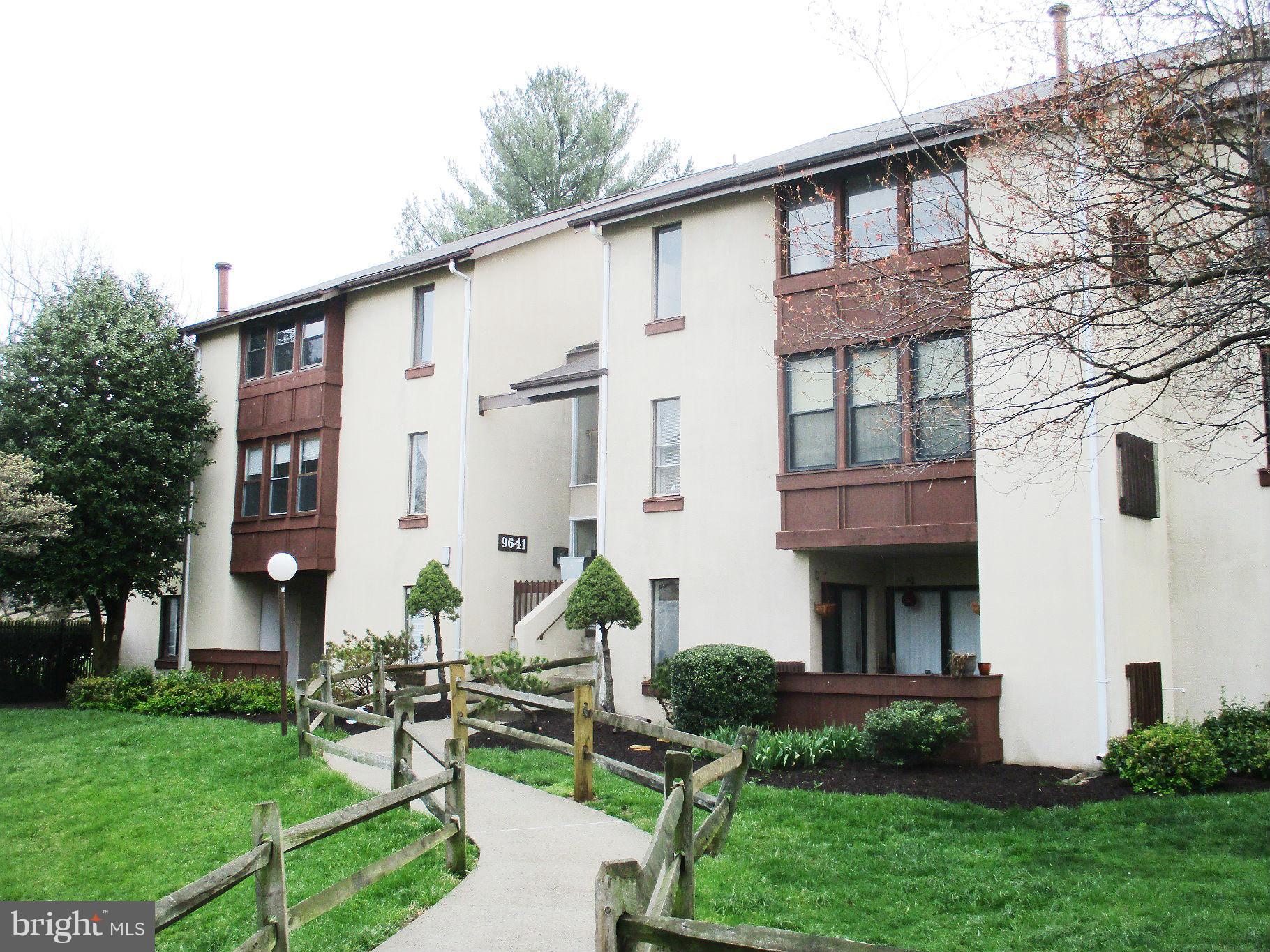 9641 White Acre Road, Unit B3 Columbia, MD 21045 - Photo 2 of 10 a front view of a house with garden and plants