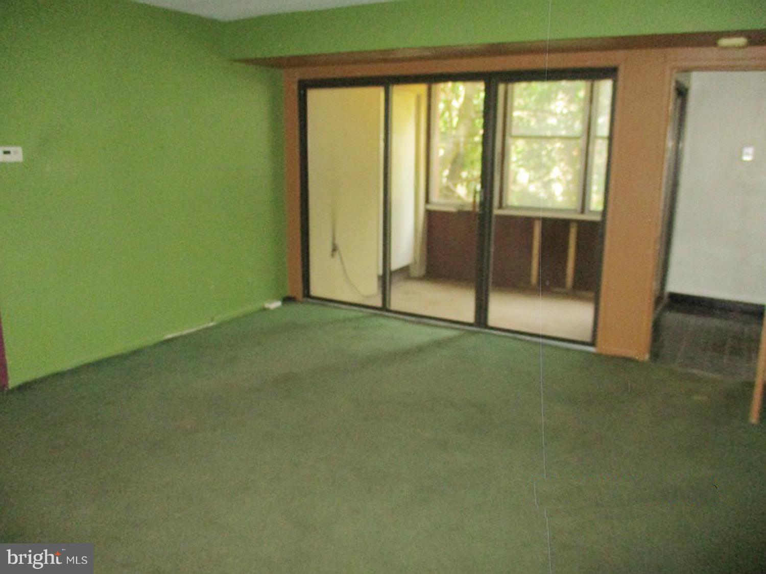 9641 White Acre Road, Unit B3 Columbia, MD 21045 - Photo 5 of 10 a view of an empty room with wooden floor and a window