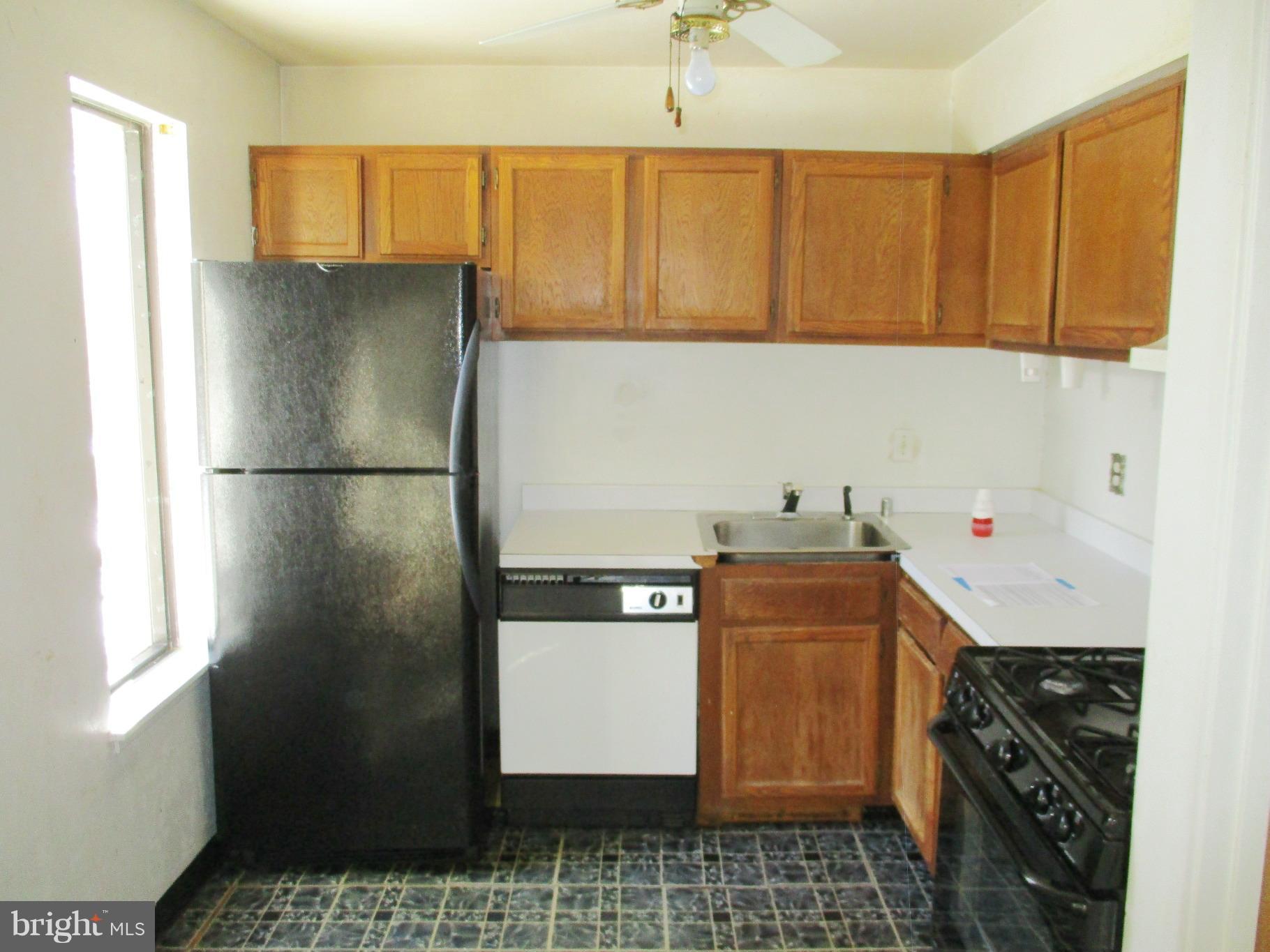 9641 White Acre Road, Unit B3 Columbia, MD 21045 - Photo 6 of 10 a kitchen with stainless steel appliances granite countertop a refrigerator a sink and dishwasher