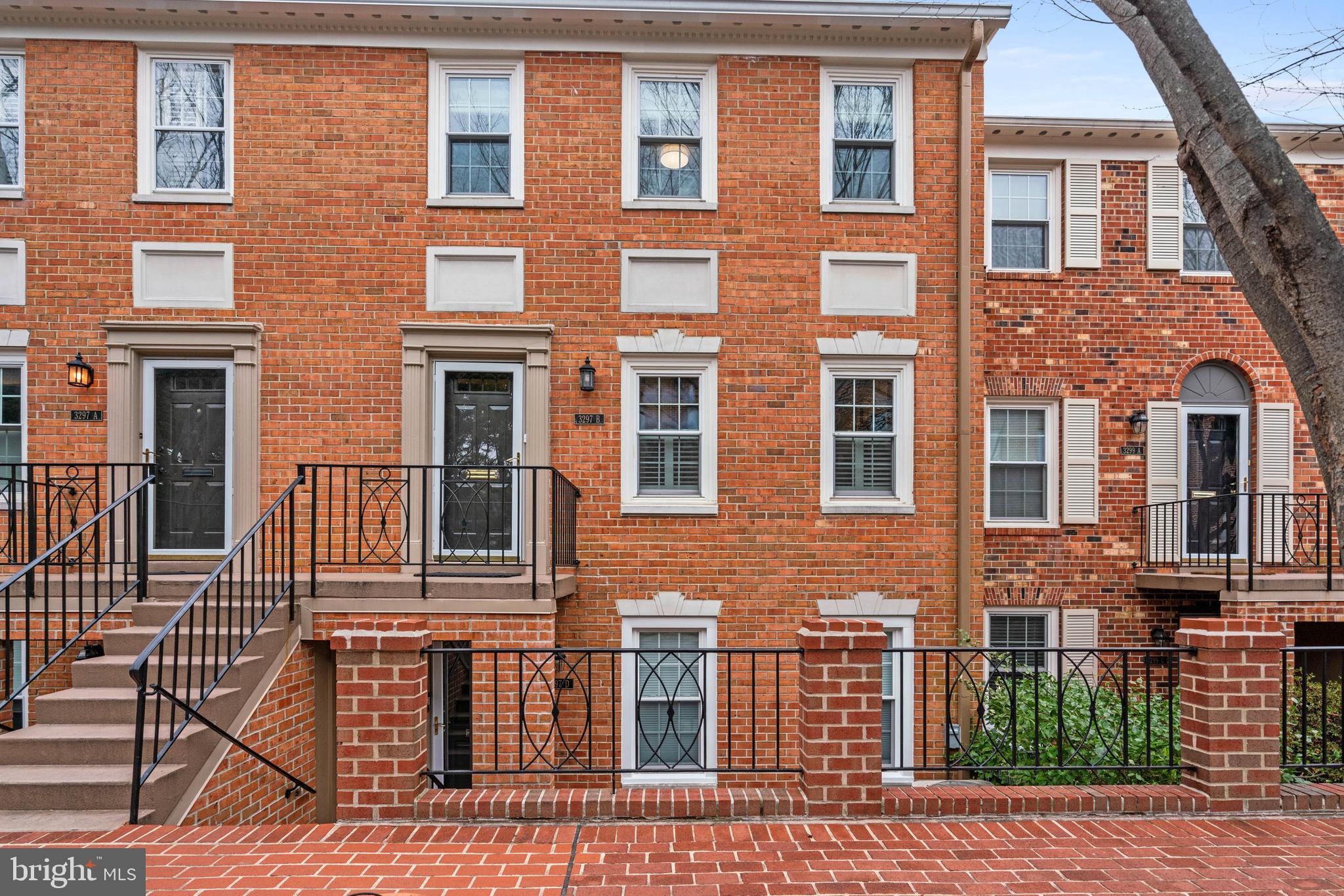 3297 Sutton Place Northwest, Unit B Washington, DC 20016 - Photo 1 of 43 a front view of a brick house many windows