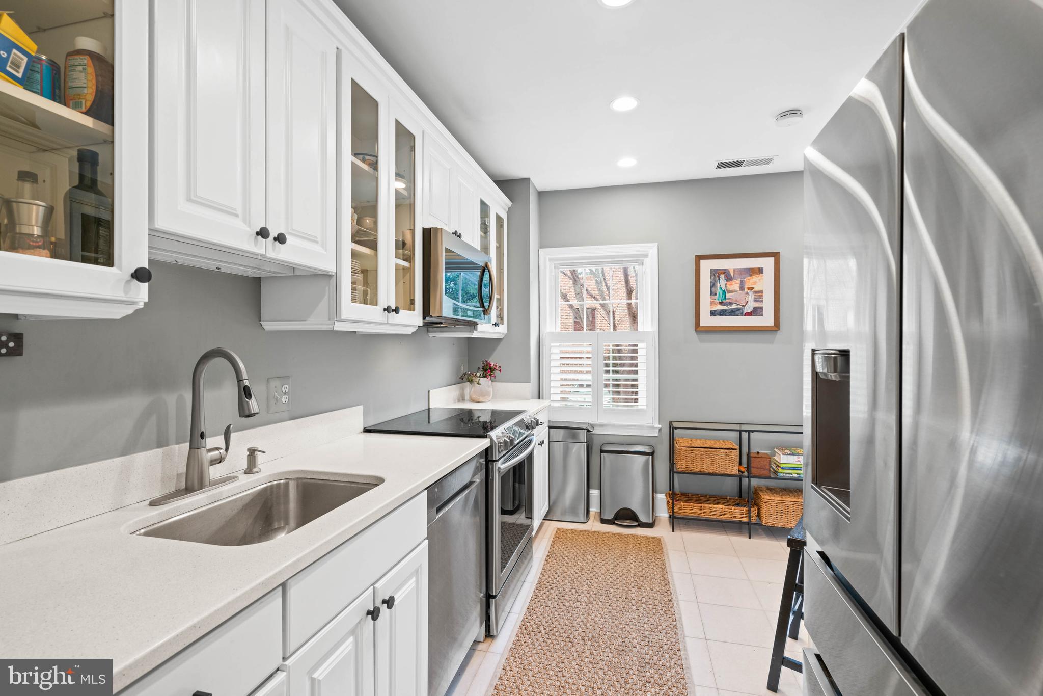 3297 Sutton Place Northwest, Unit B Washington, DC 20016 - Photo 14 of 43 a kitchen with stainless steel appliances granite countertop a refrigerator sink and stove