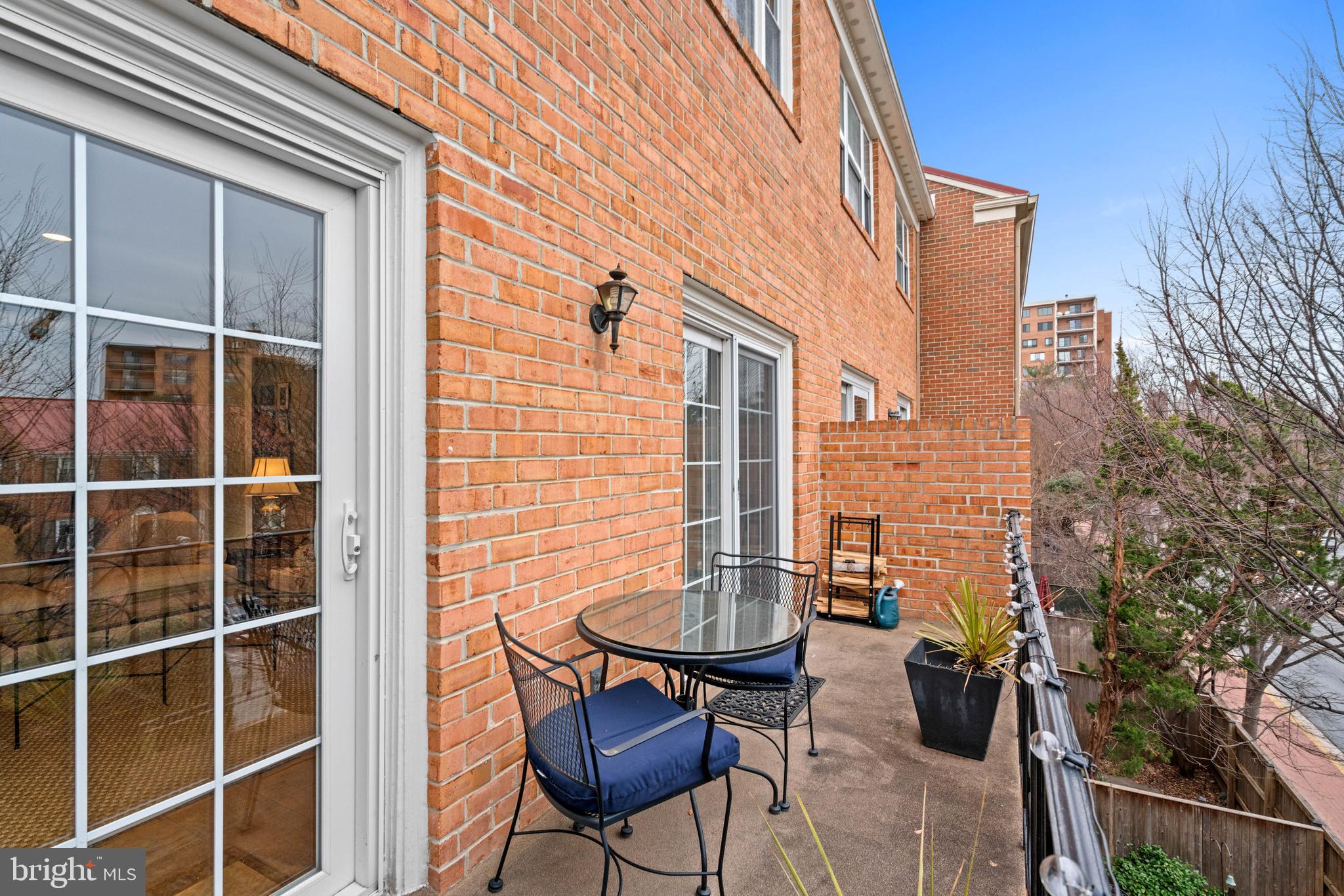 3297 Sutton Place Northwest, Unit B Washington, DC 20016 - Photo 25 of 43 a backyard of a house with table and chairs