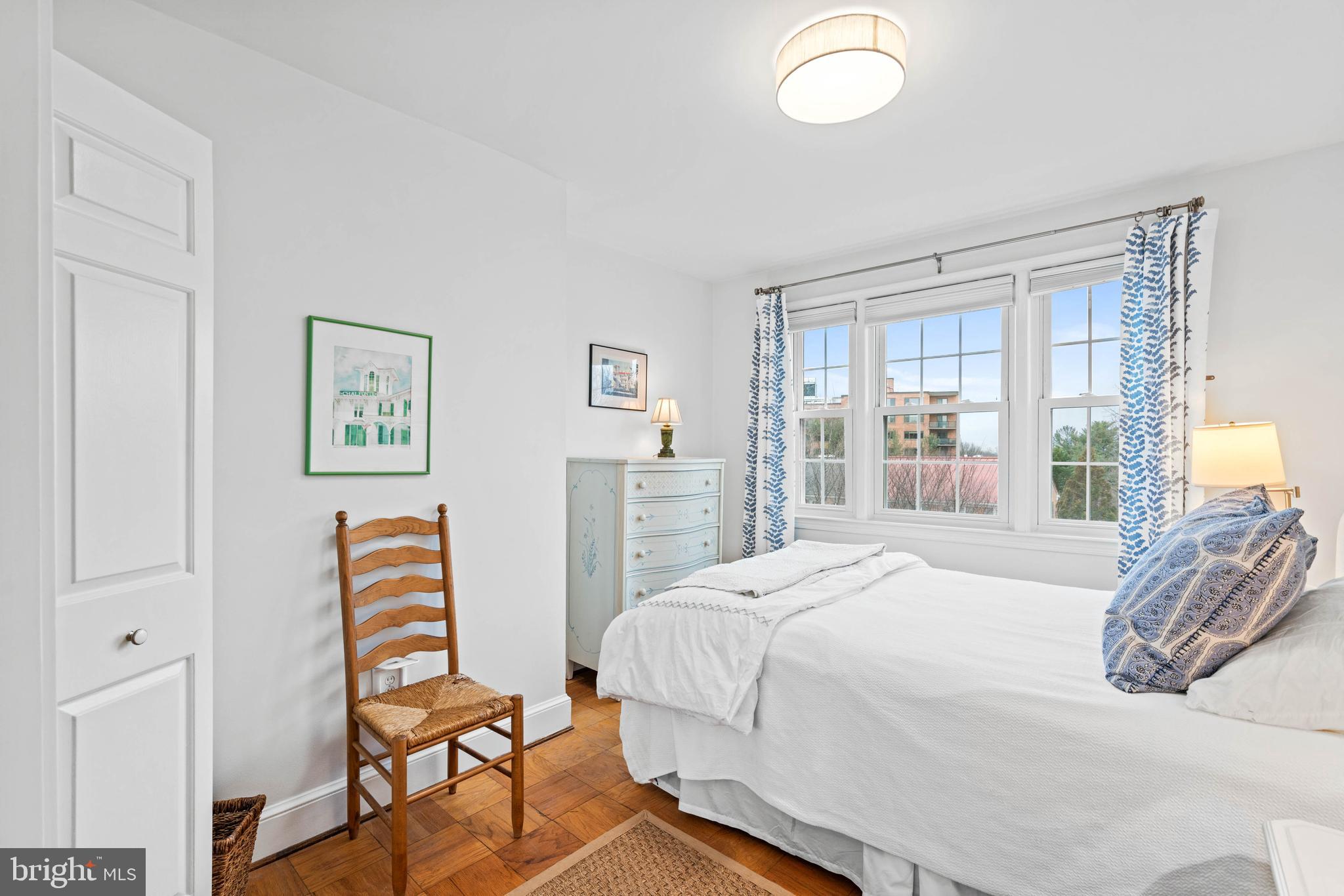 3297 Sutton Place Northwest, Unit B Washington, DC 20016 - Photo 31 of 43 a bedroom with a bed and wooden floor