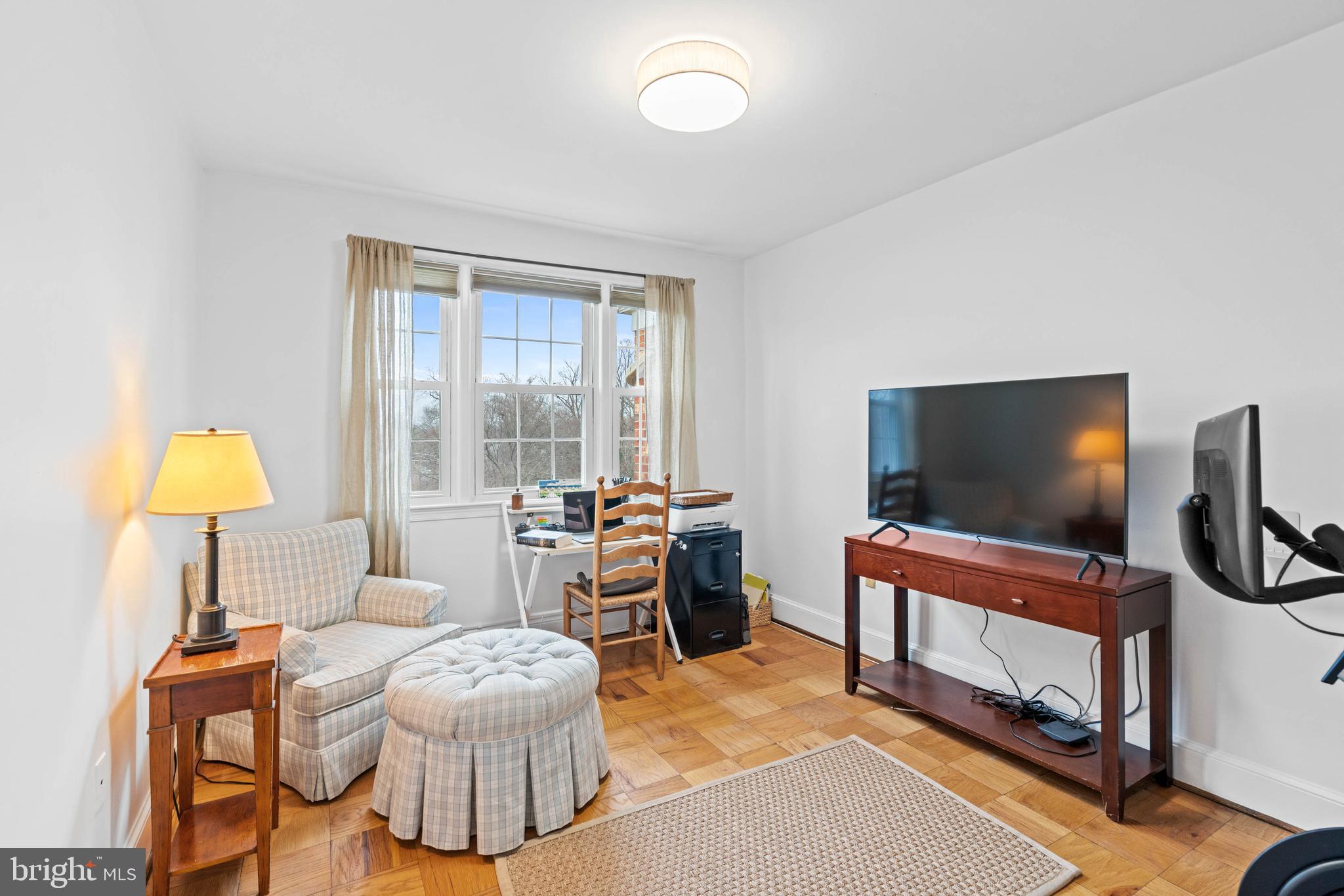 3297 Sutton Place Northwest, Unit B Washington, DC 20016 - Photo 32 of 43 a living room with furniture and a flat screen tv