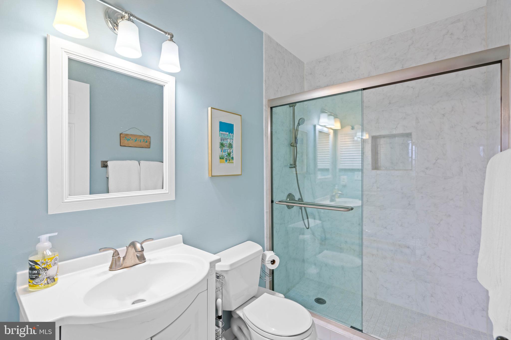 3297 Sutton Place Northwest, Unit B Washington, DC 20016 - Photo 34 of 43 a bathroom with a toilet sink vanity and shower