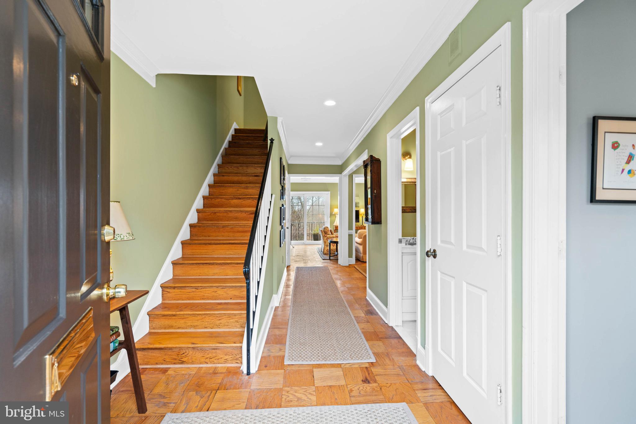 3297 Sutton Place Northwest, Unit B Washington, DC 20016 - Photo 8 of 43 a view of a hallway with wooden floor and staircase