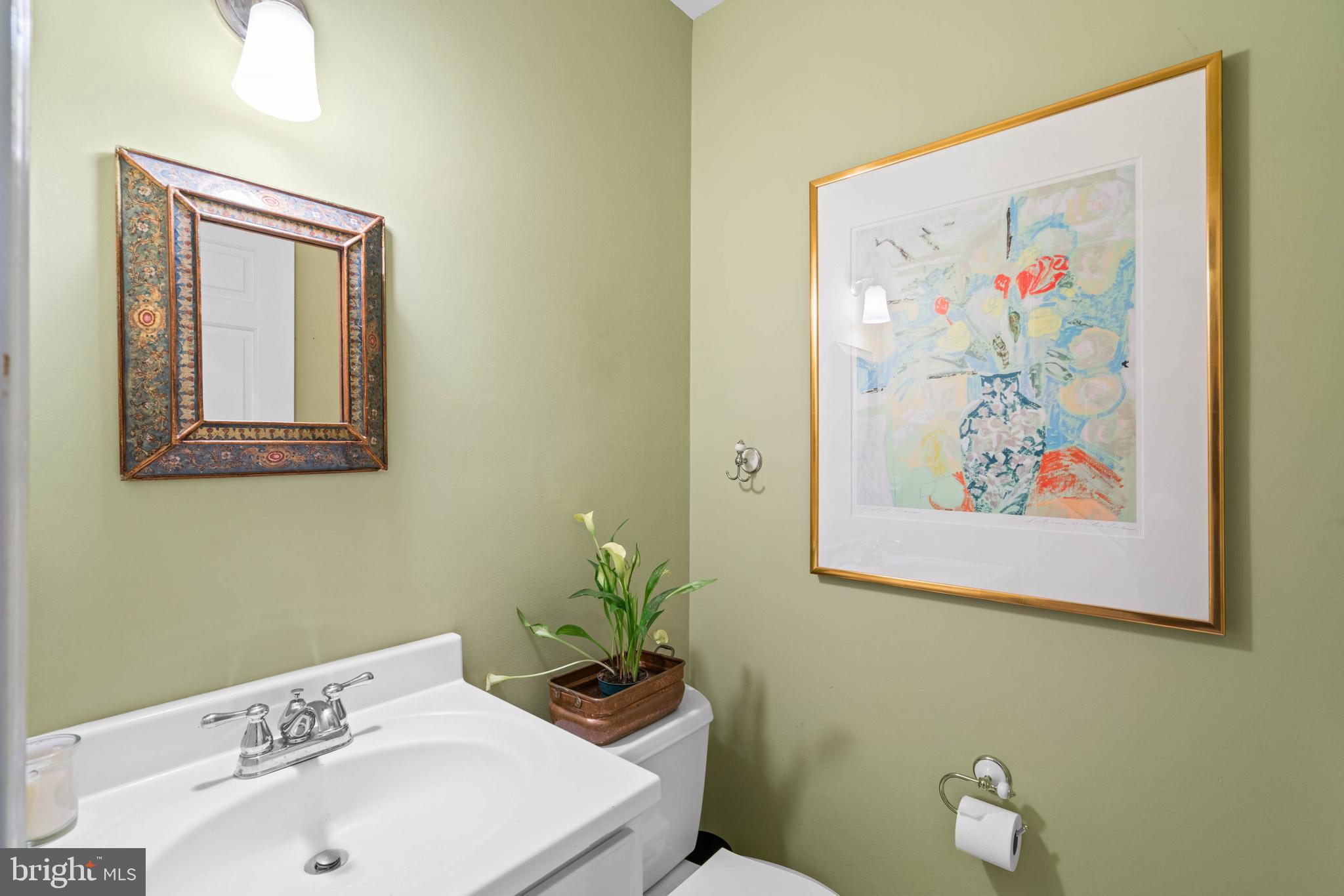 3297 Sutton Place Northwest, Unit B Washington, DC 20016 - Photo 10 of 43 a bathroom with a sink mirror and toilet