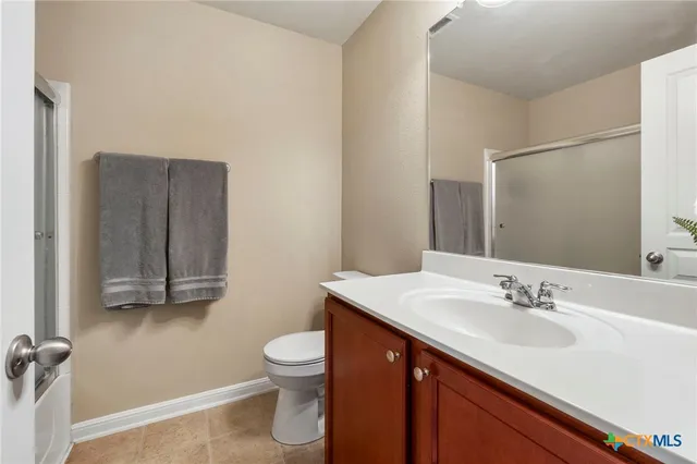 a bathroom with a sink toilet and vanity