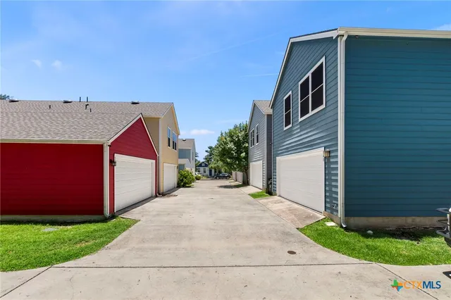 a view of a house with a backyard