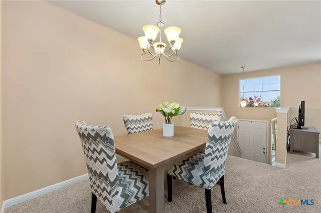 a dining room with furniture and chandelier