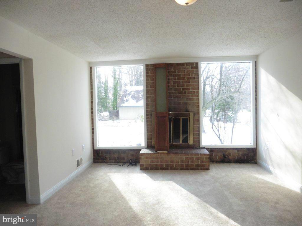 9429 Kilimanjaro Road Columbia, MD 21045 - Photo 2 of 13 a living room with furniture and a fireplace
