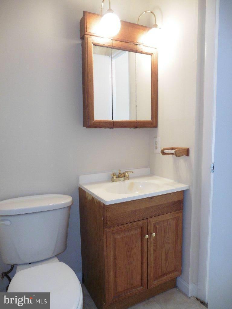 9429 Kilimanjaro Road Columbia, MD 21045 - Photo 11 of 13 a bathroom with a toilet a sink and mirror
