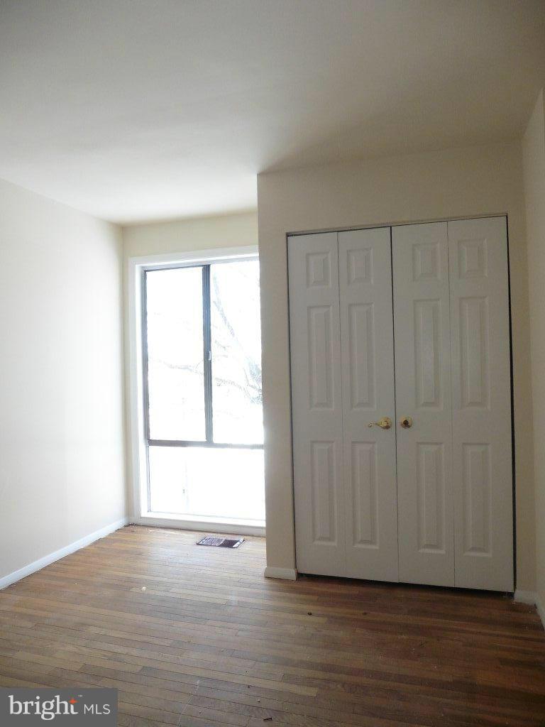 9429 Kilimanjaro Road Columbia, MD 21045 - Photo 10 of 13 a view of an empty room with wooden floor and a window