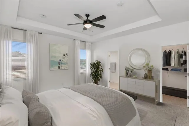 a bedroom with a large bed and a chandelier