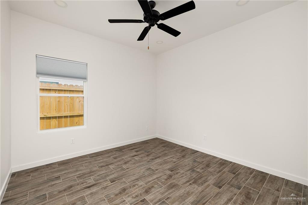 2608 Robin Road Weslaco, TX 78596 - Photo 9 of 14 an empty room with a window and a ceiling fan
