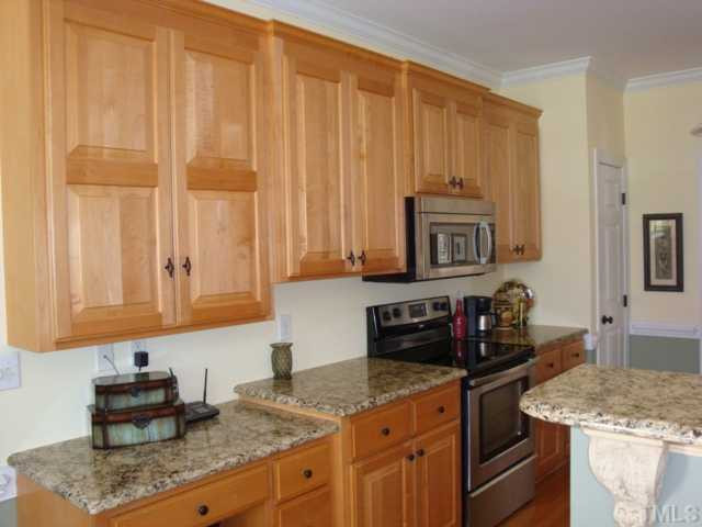 2845 Anfield Road Raleigh, NC 27606 - Photo 5 of 25 Kitchen features Custom Cabinets with Built-in Desk Area, Granite Countertops, Stainless Steel Appliances and Pantry Kitchen