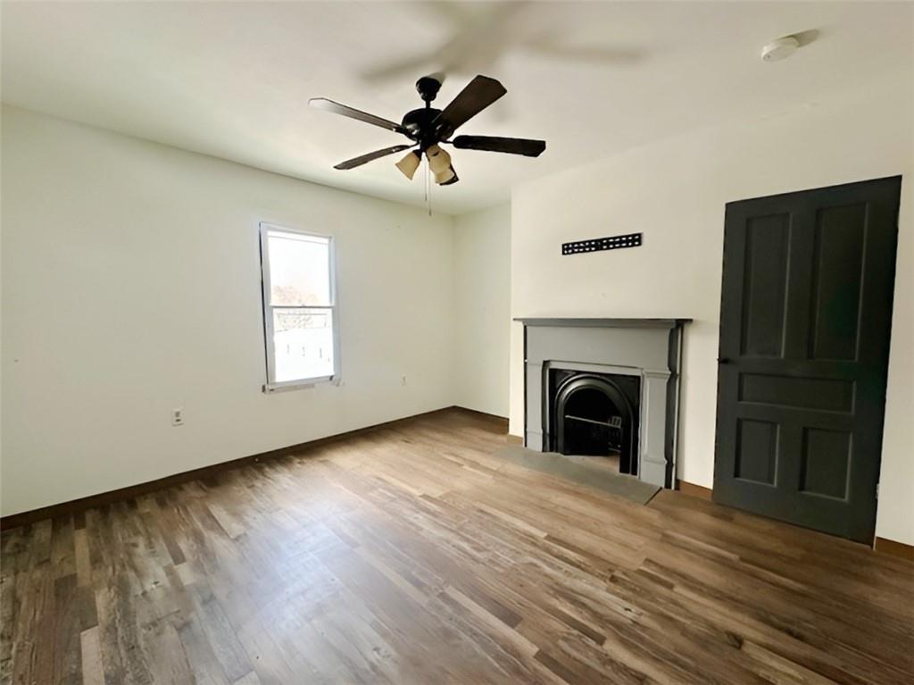 910 9th Avenue Beaver Falls, PA 15010 - Photo 11 of 11 a view of empty room with wooden floor and fireplace