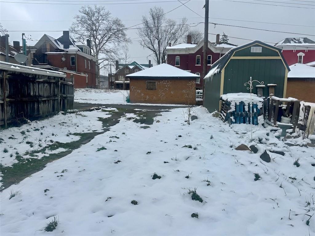 910 9th Avenue Beaver Falls, PA 15010 - Photo 2 of 11 a front view of a house with a yard covered in snow