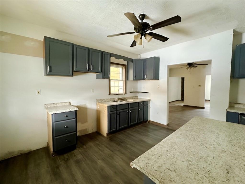 910 9th Avenue Beaver Falls, PA 15010 - Photo 4 of 11 a kitchen with a stove a sink and a refrigerator