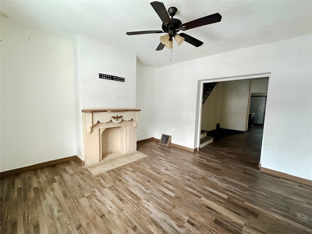 910 9th Avenue Beaver Falls, PA 15010 - Photo 7 of 11 a view of a livingroom with wooden floor and a ceiling fan