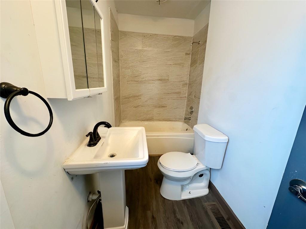 910 9th Avenue Beaver Falls, PA 15010 - Photo 8 of 11 a bathroom with a sink toilet and mirror