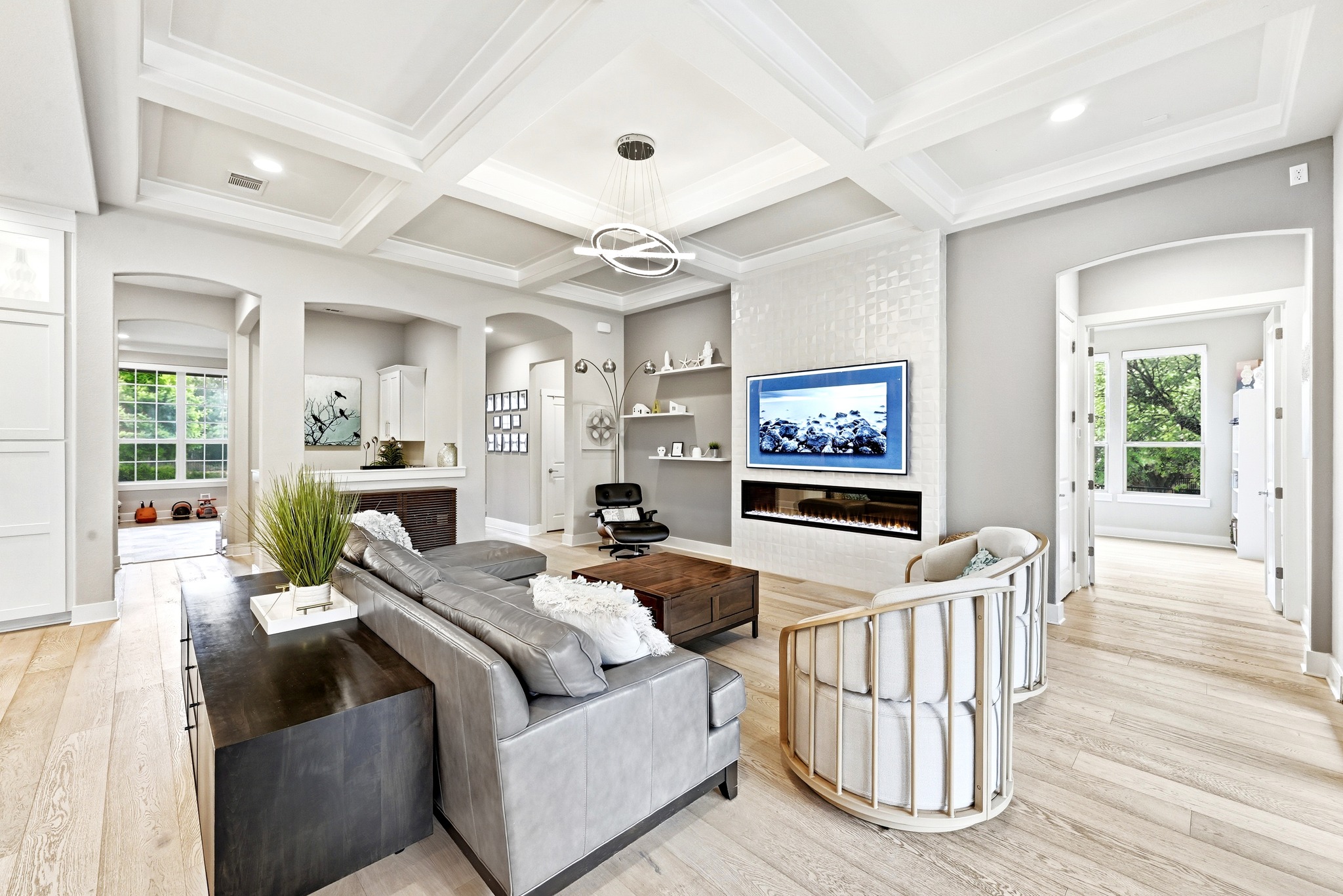 9008 Harper Rae Drive Austin, TX 78717 - Photo 9 of 39 Living area featuring a coffered ceiling with recessed lighting, light wood-finish flooring, and arched doorways