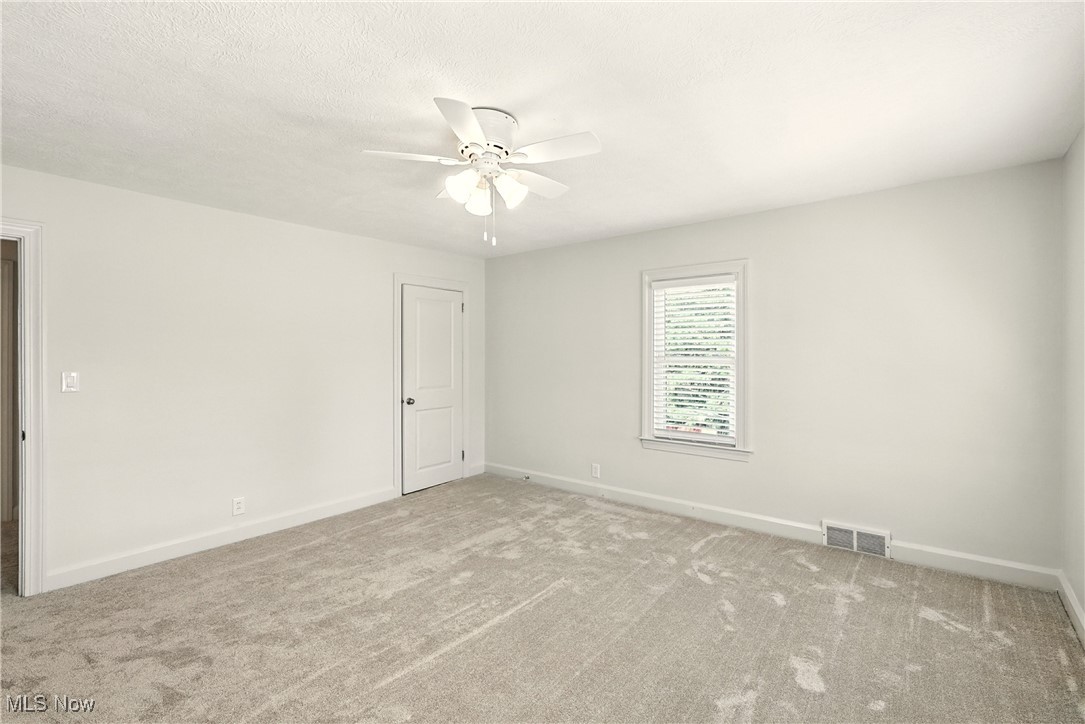 2844 Kent Road Stow, OH 44224 - Photo 28 of 47 Carpeted spare room with baseboards and ceiling fan
