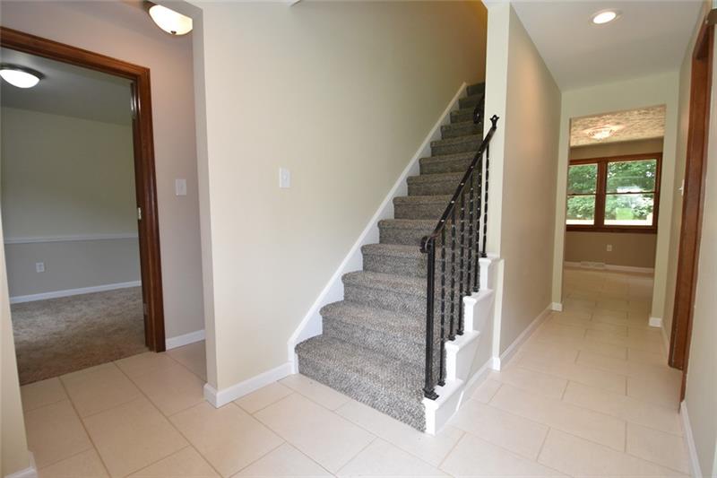 2405 Mill Grove Road Pittsburgh, PA 15241 - Photo 2 of 14 Welcoming front entry of 11' x 5' with new neutral porcelain tile into the updated eat-in-kitchen, den, formal living room and first floor powder room! Freshly painted through out with lots of open space and open floor plan.