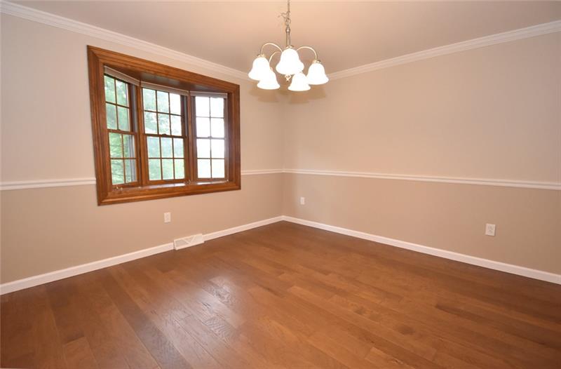 2405 Mill Grove Road Pittsburgh, PA 15241 - Photo 5 of 14 The formal dining room is 12' x 12' and has new hardwood flooring, bay window, chair rail molding and crown molding. Image entertaining your family and friends in this newly remodeled home.