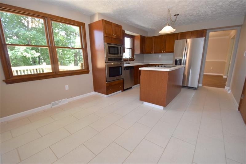 2405 Mill Grove Road Pittsburgh, PA 15241 - Photo 7 of 14 WOW! So much space! You can eat at the island or have a large table and chairs, too! Just move right in, nothing to do but unpack! All new stainless steel appliances. This kitchen overlooks the oversized new deck.