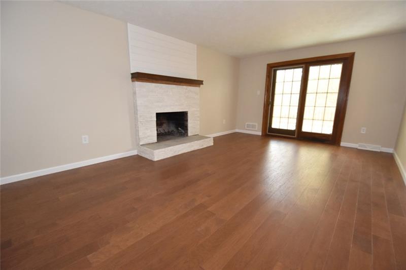 2405 Mill Grove Road Pittsburgh, PA 15241 - Photo 8 of 14 The First floor family room is 19' x 13' and has gleaming hard wood flooring, near hearth and easy access to the new deck. Clean lines and look! Beautiful!