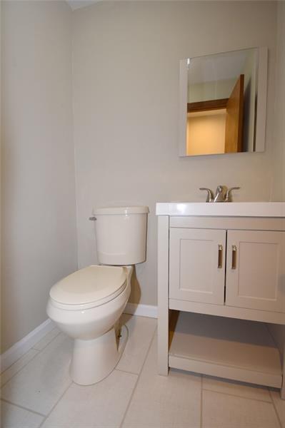 2405 Mill Grove Road Pittsburgh, PA 15241 - Photo 10 of 14 First floor powder room...everything is new! New toilet, new vanity, new faucet, porcelain tile floor and mirror.