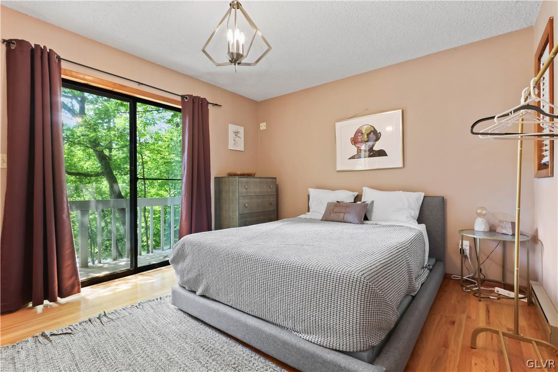 6463 Decker Road Bushkill, PA 18324 - Photo 29 of 50 a bedroom with a large bed and a large window
