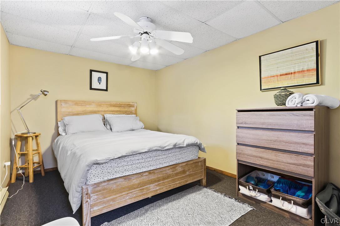 6463 Decker Road Bushkill, PA 18324 - Photo 35 of 50 a bedroom with a bed and a chandelier