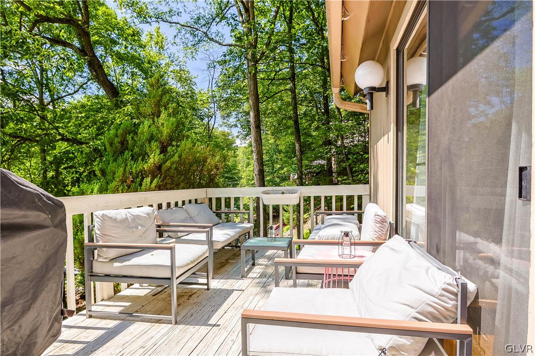 6463 Decker Road Bushkill, PA 18324 - Photo 5 of 50 a balcony with wooden floor table and chairs